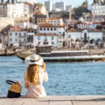 US expat sitting on a dock facing the water