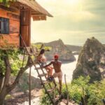 Treehouse on a tropical island with a heterosexual couple relaxing outside