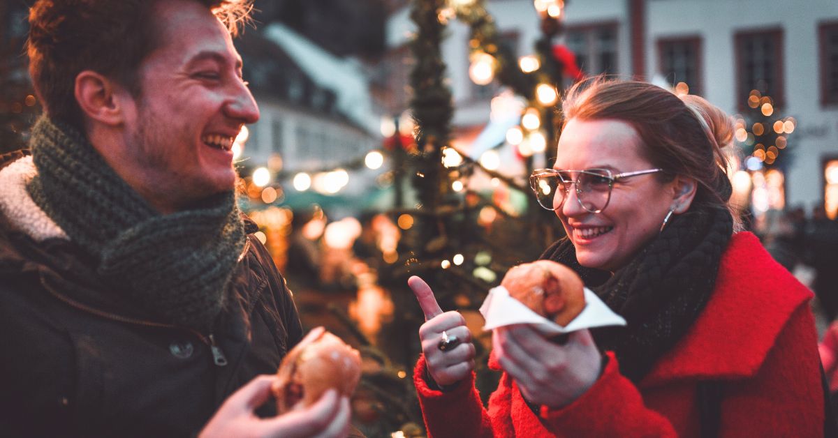 How to avoid homesickness is a challenging question for expats living outside the US. Pictured: two expats at a Christmas market.