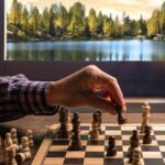 US expat plays chess, a visual analogy of the strategy necessary behind changing state residency when living abroad.