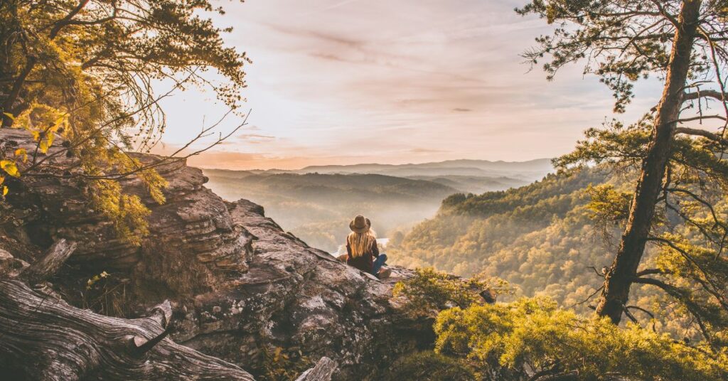 US expat contemplates the horizon during a hike in Eastern Europe.