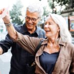 Americans retiring in France explore a local market and select postcards to send to loved ones in the US.