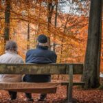 Retiring in Japan as a foreigner is actually quite a common occurence for Americans. Pictured: two older expats sitting in on a bench in the fall.