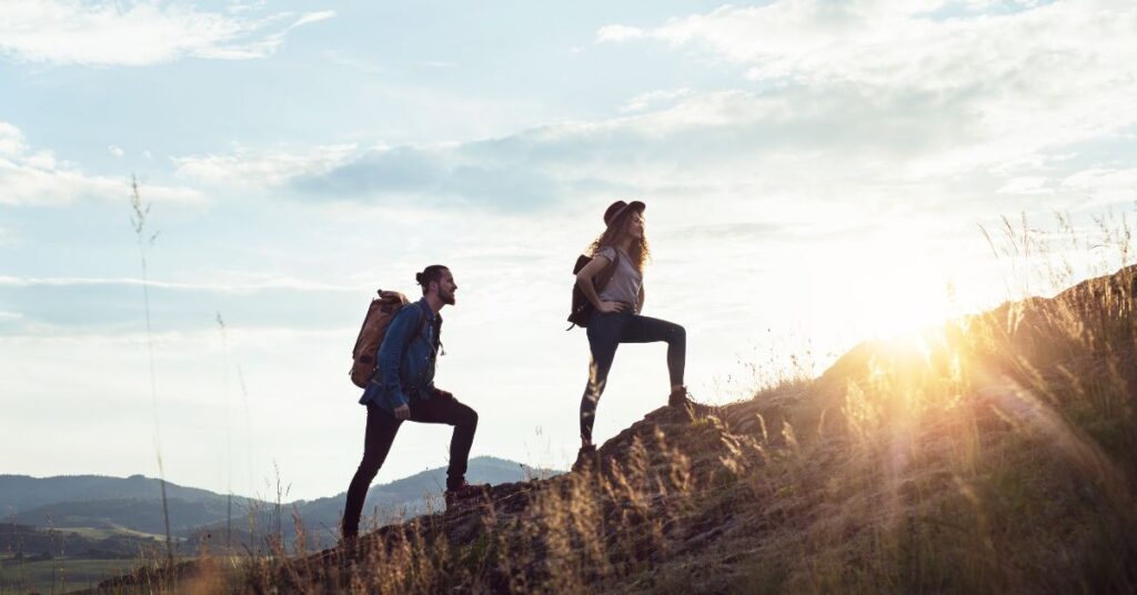 Two hikers in Canada silhouetted against the sky