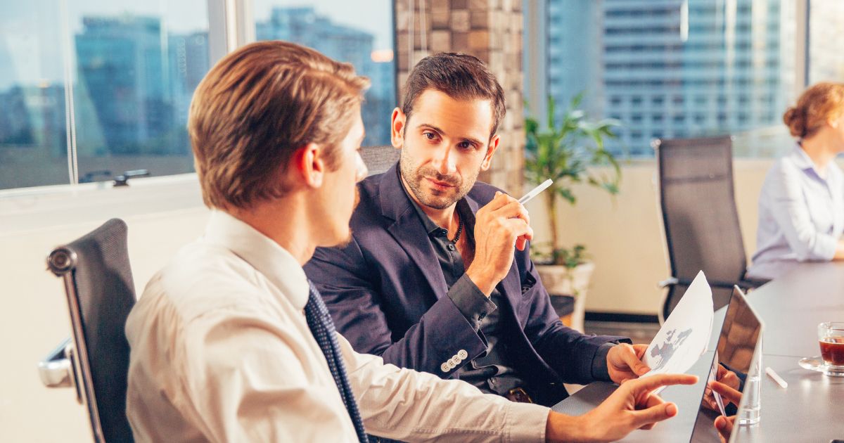 Two men discuss renouncing US citizenship in an office high-rise