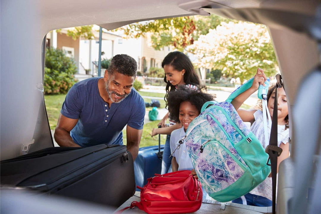 Family using a road trip checklist to pack for their vacation